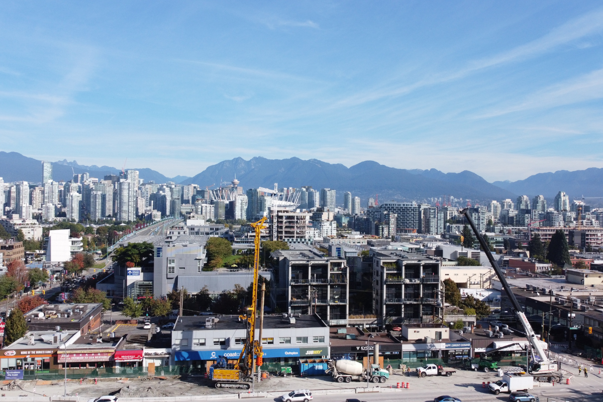jobsite in a city with buildings and the mountains behind