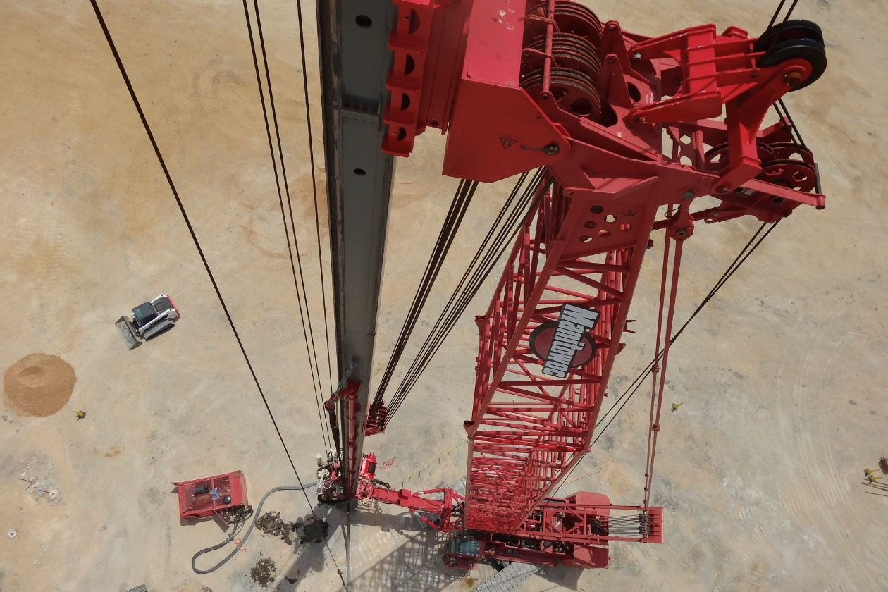 Drone photo of a red crane on a jobsite