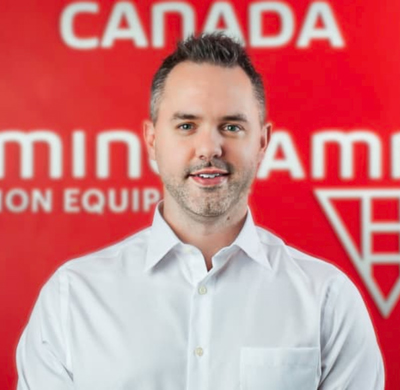 Photo of Sean Morrisroe in SBC's office with a red background and the Soletanche Bachy Canada and Berminghammer logos