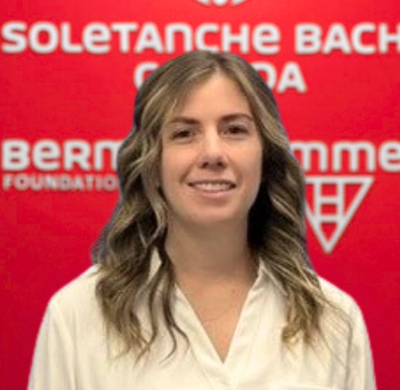 Photo of Chantel Richard in SBC's office with a red background and the Soletanche Bachy Canada and Berminghammer logos