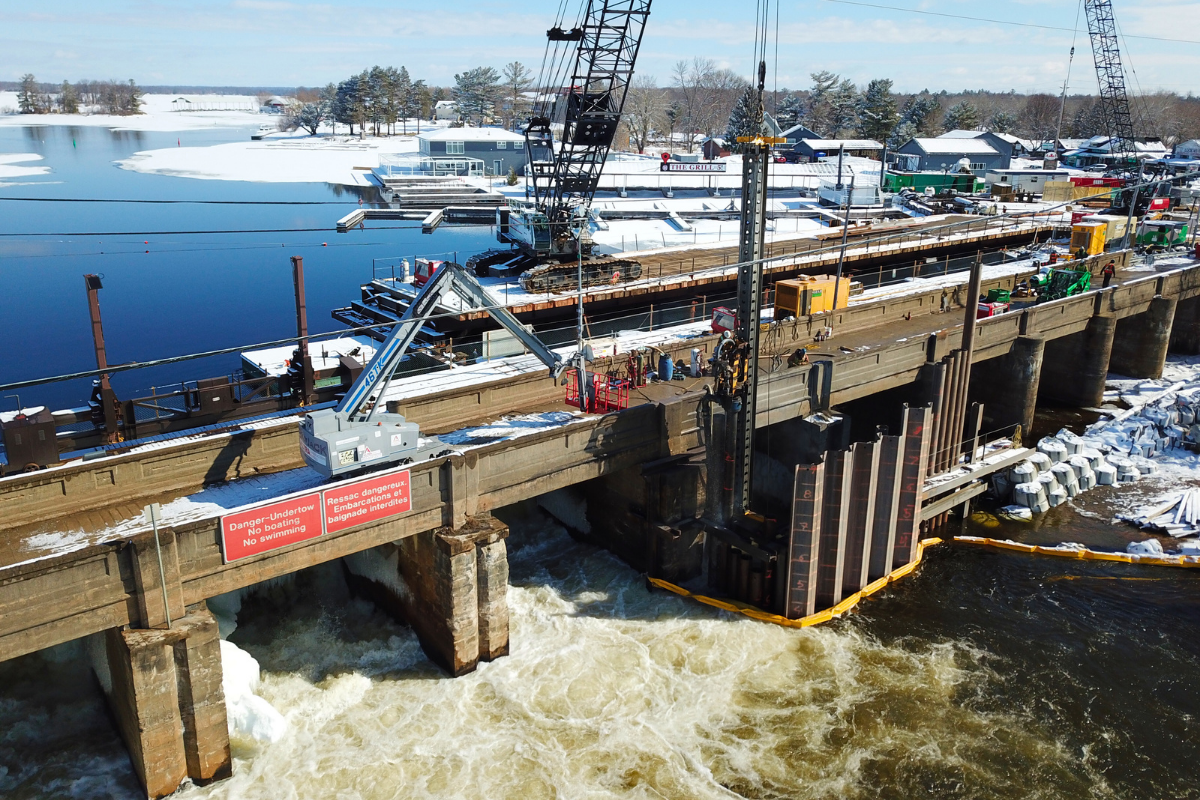 jobsite with cranes on a dam bridge