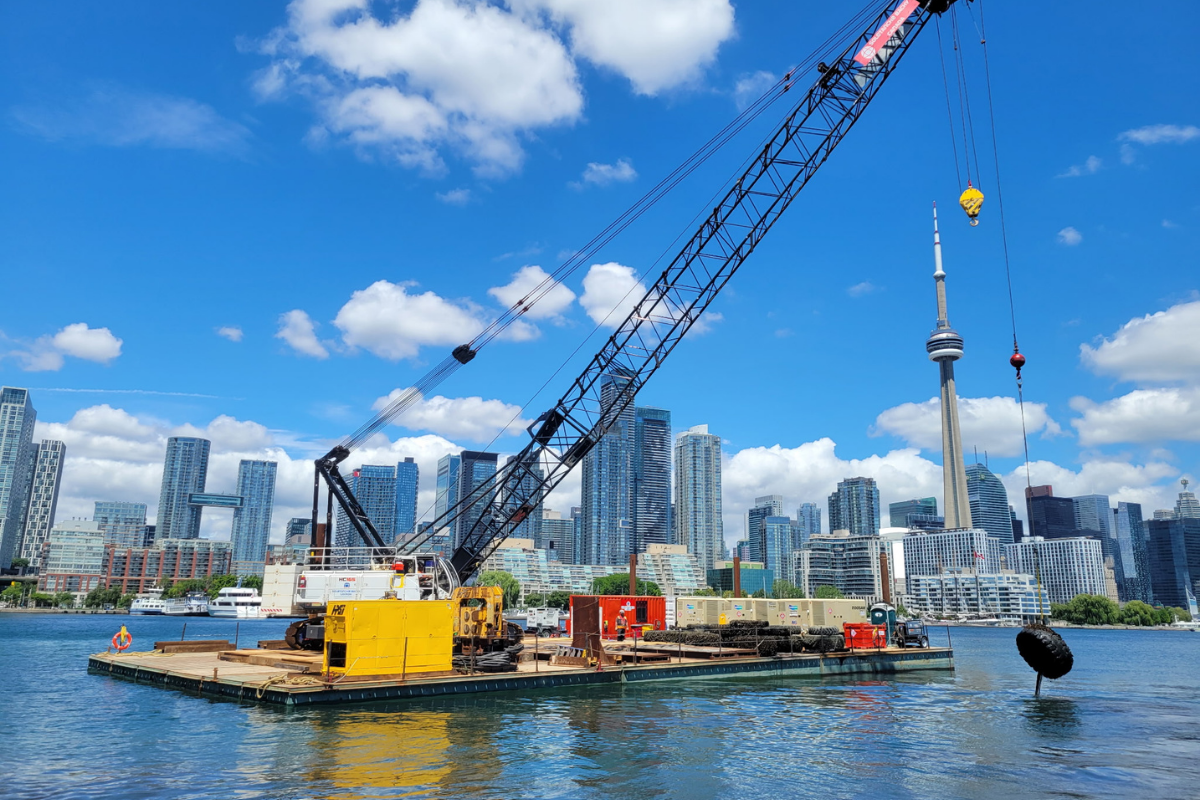 marine jobsite with Toronto buildings and tower in the background