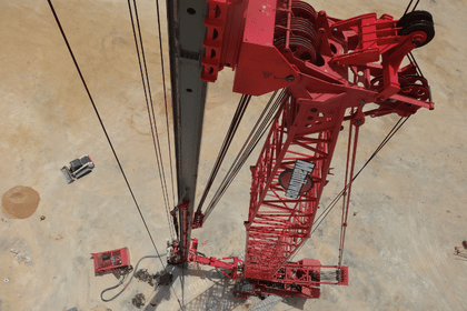 Drone photo of a red crane on a jobsite