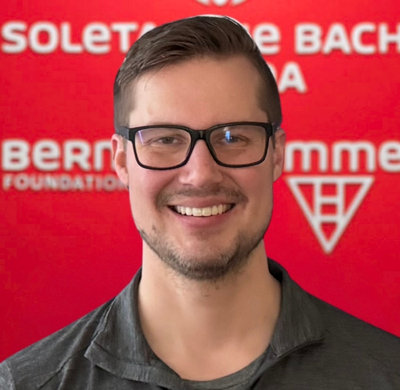 Brian Harmata Photo of Brian Harmata in SBC's office with a red background and the Soletanche Bachy Canada and Berminghammer logos